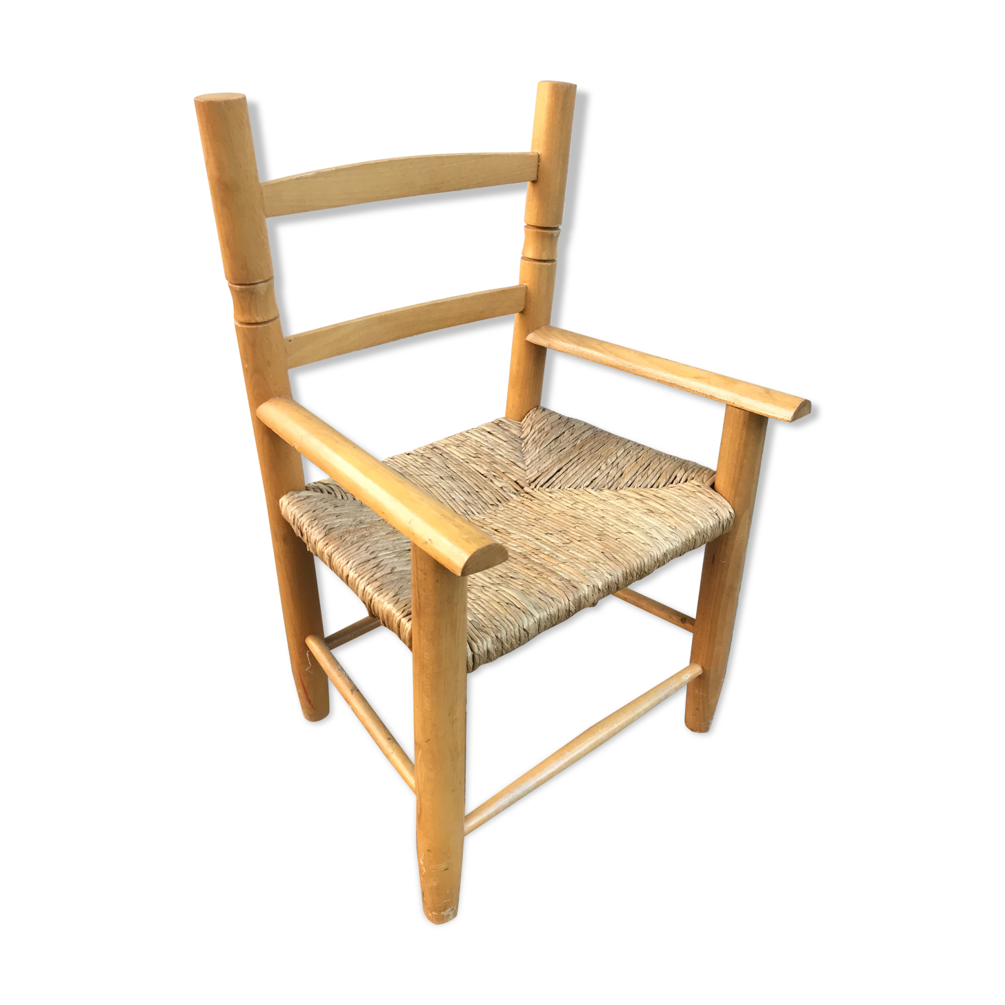 Old wooden children's armchair and vintage woven straw seat