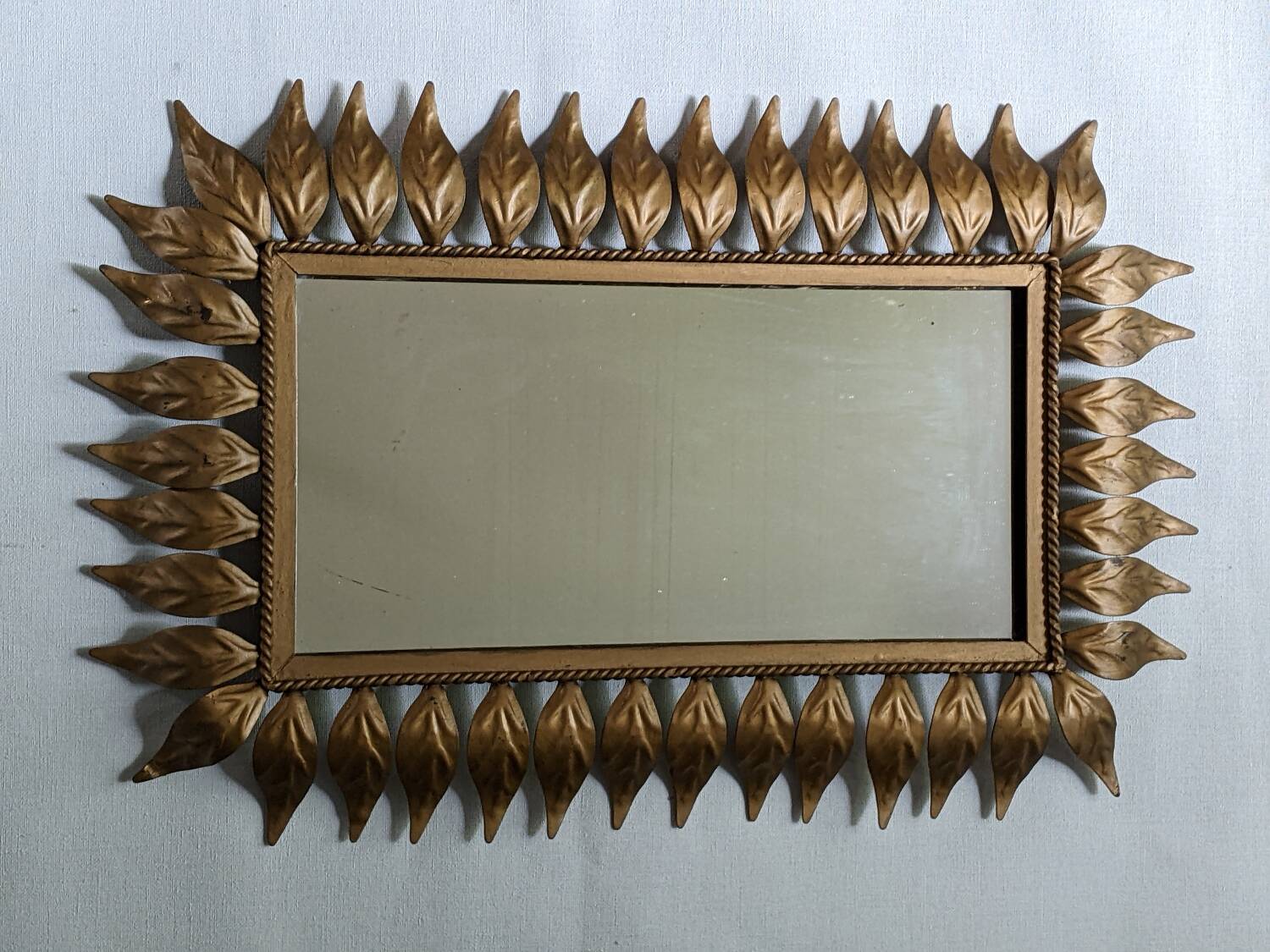 Vintage gold metal mirror with leaves from the 1950s.