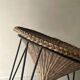 Italian basket chair in rattan and black metal, 1950s design.