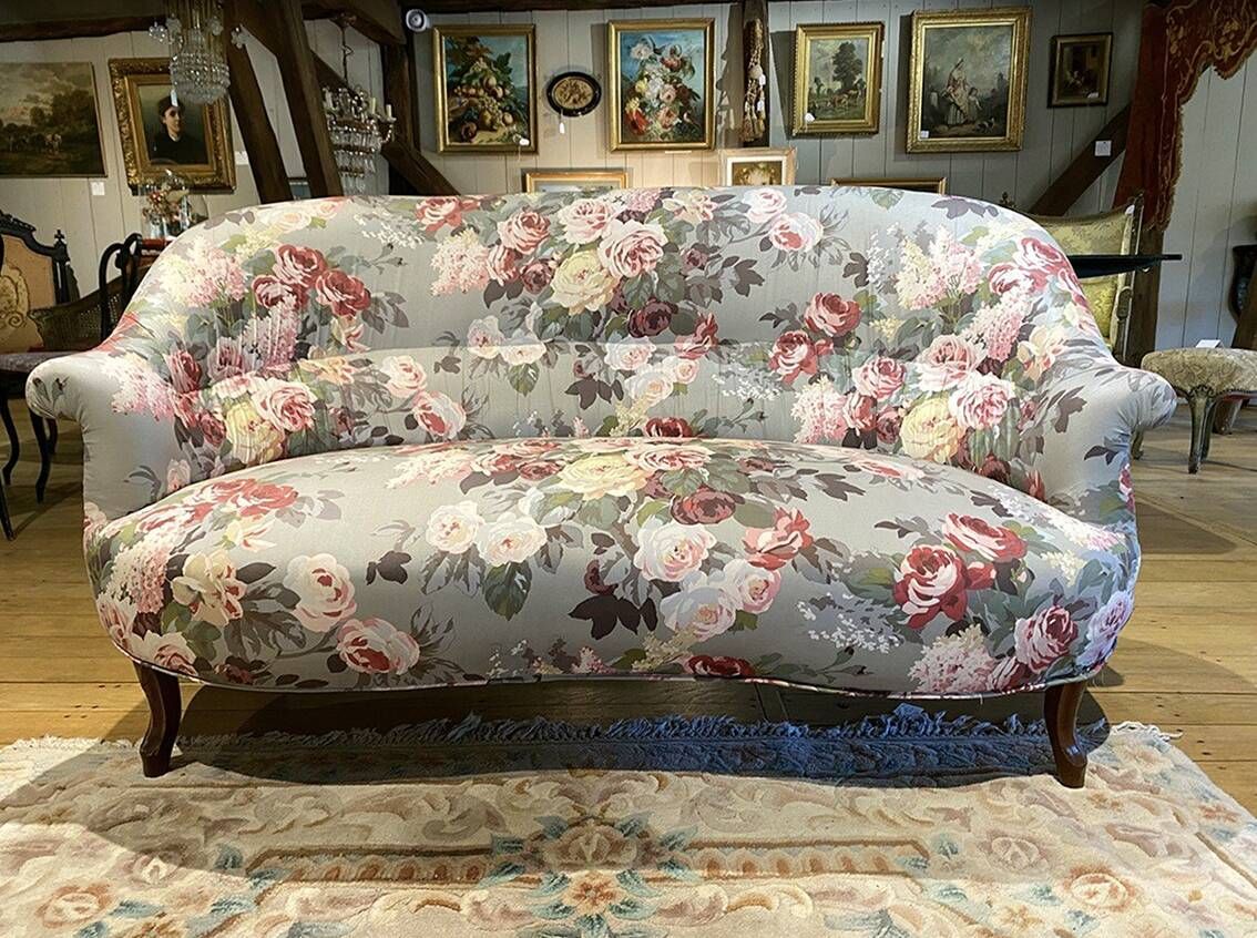 Set of two toad-shaped sofas covered in floral fabric.