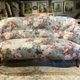 Set of two toad-shaped sofas covered in floral fabric.