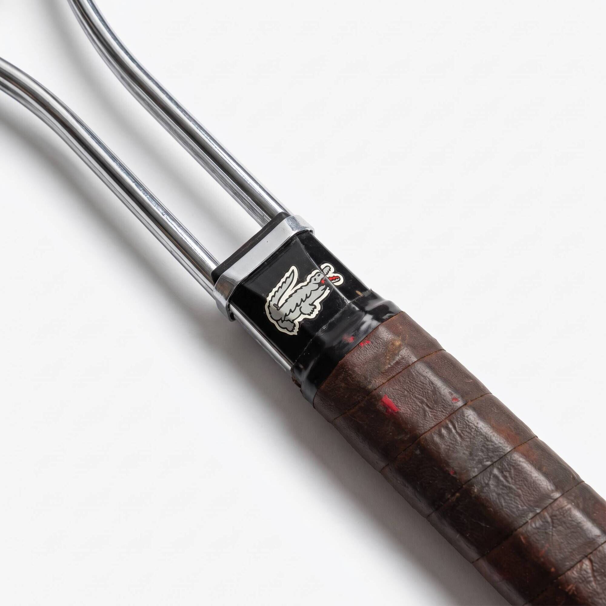 Vintage metal tennis racket by Lacoste, French design by René Lacoste.