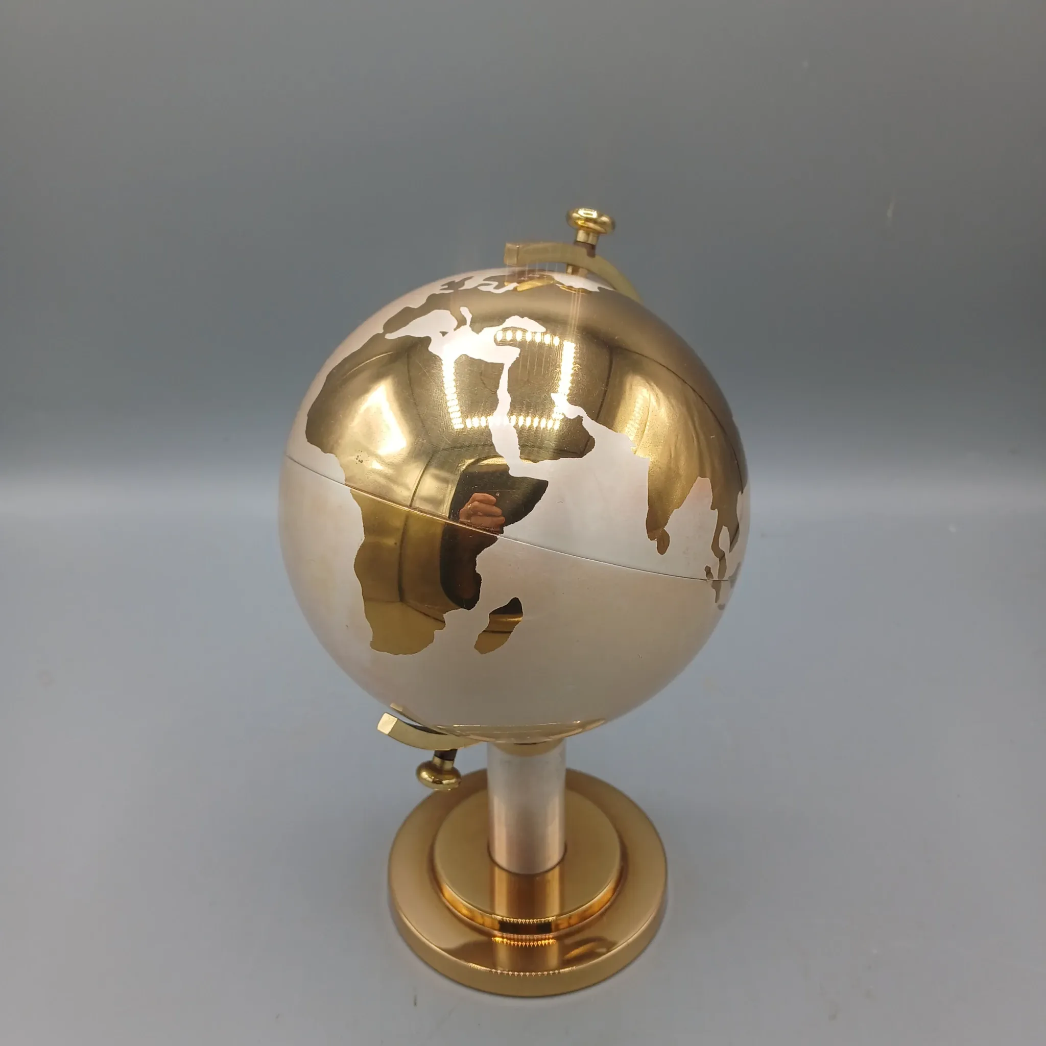 Vintage brass globe cigarette dispenser