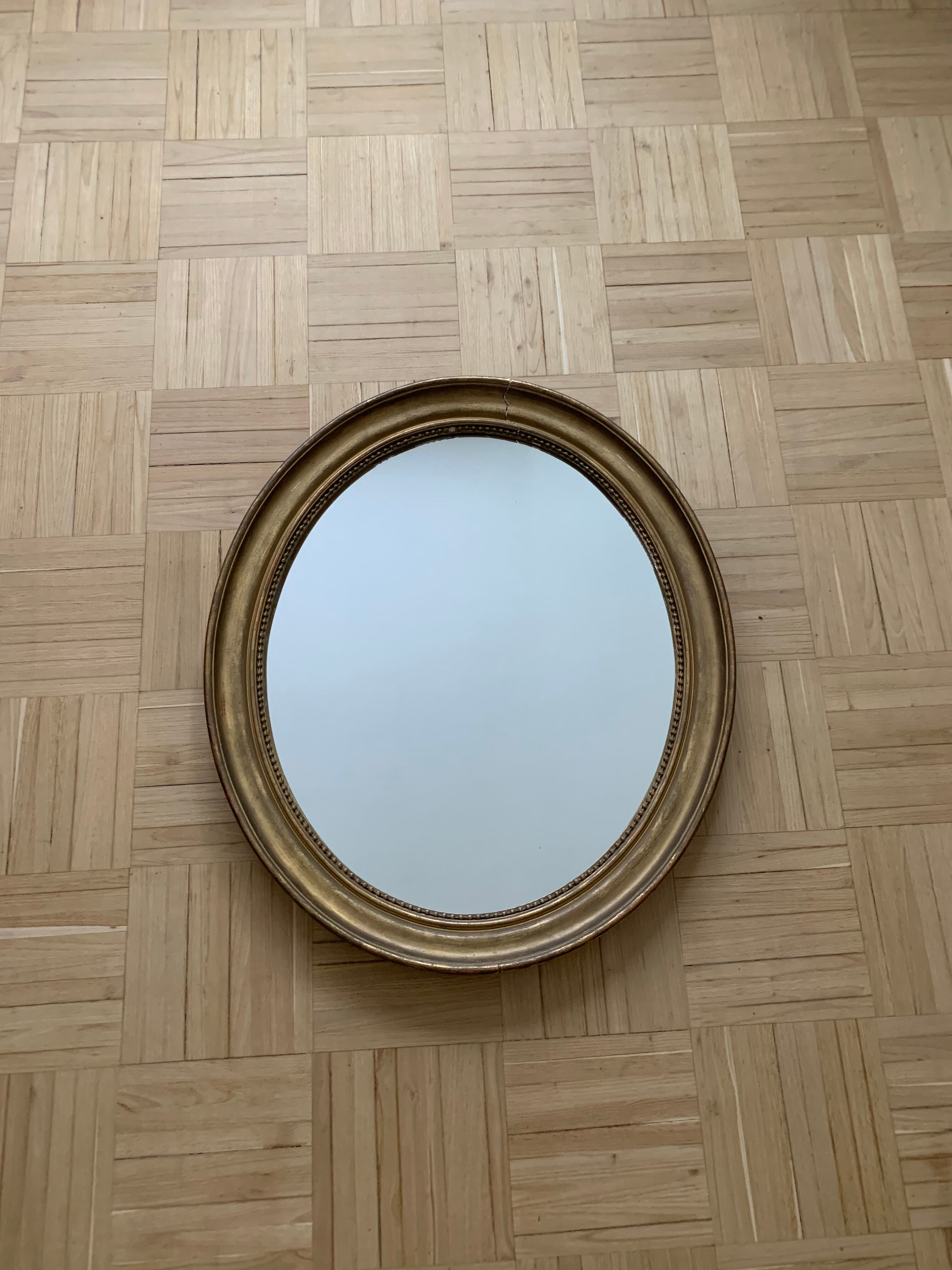 Old oval golden mirror