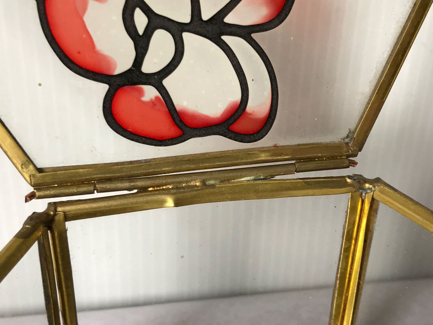 Glass box and hexagonal brass enamelled floral decoration