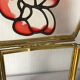 Glass box and hexagonal brass enamelled floral decoration