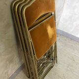 Four folding velvet and brass chairs