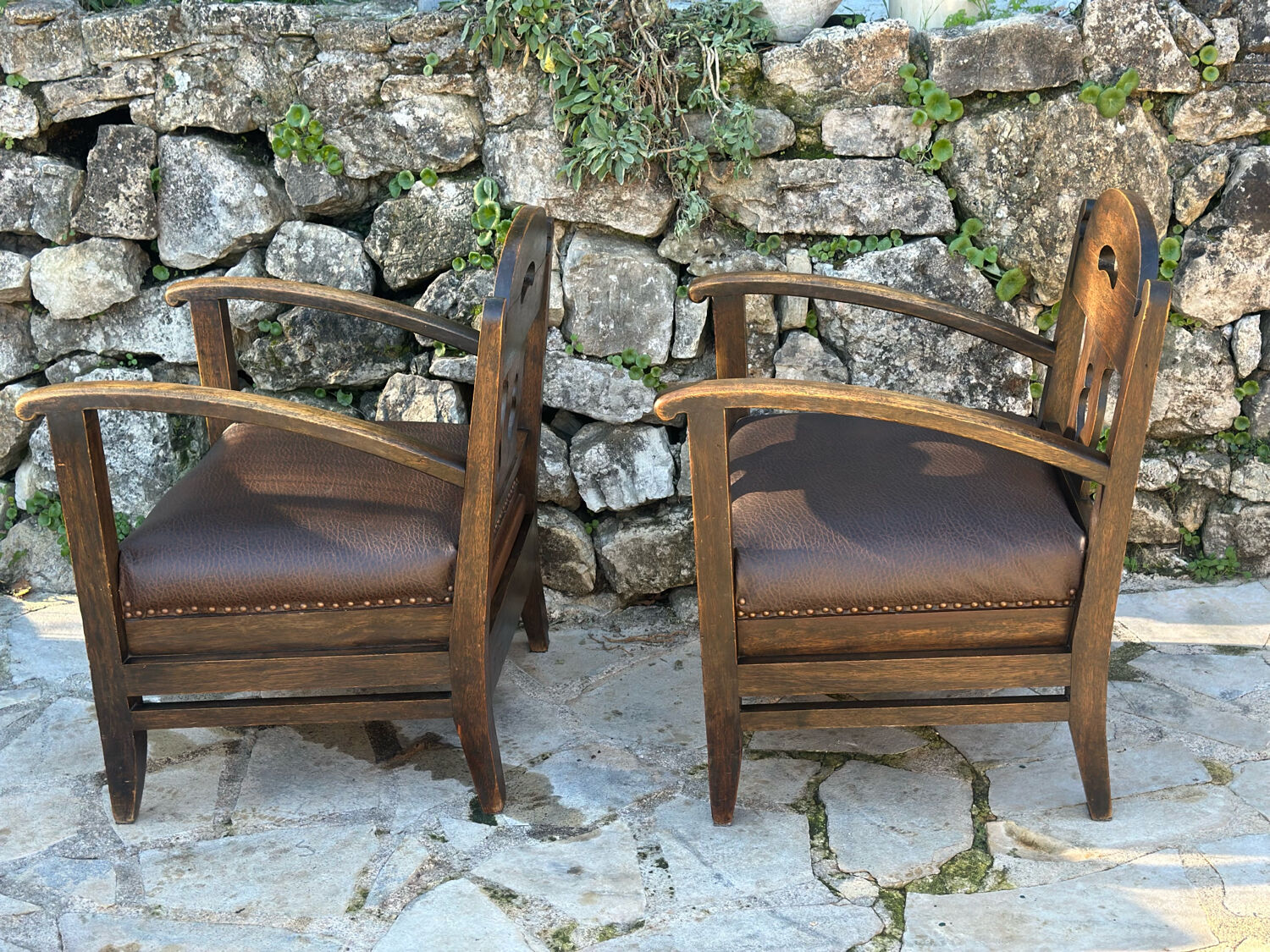 Pair of armchairs in stained wood and leather, 20th century