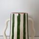 Handmade green and white striped ceramic vase with abstract corrugated handheld