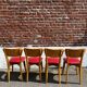 Set of 4 vintage bistro chairs in wood and red faux leather, with splayed legs.