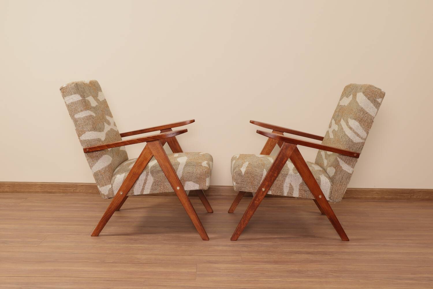 Pair of vintage lounge chairs in brown jacquard fabric and wood.
