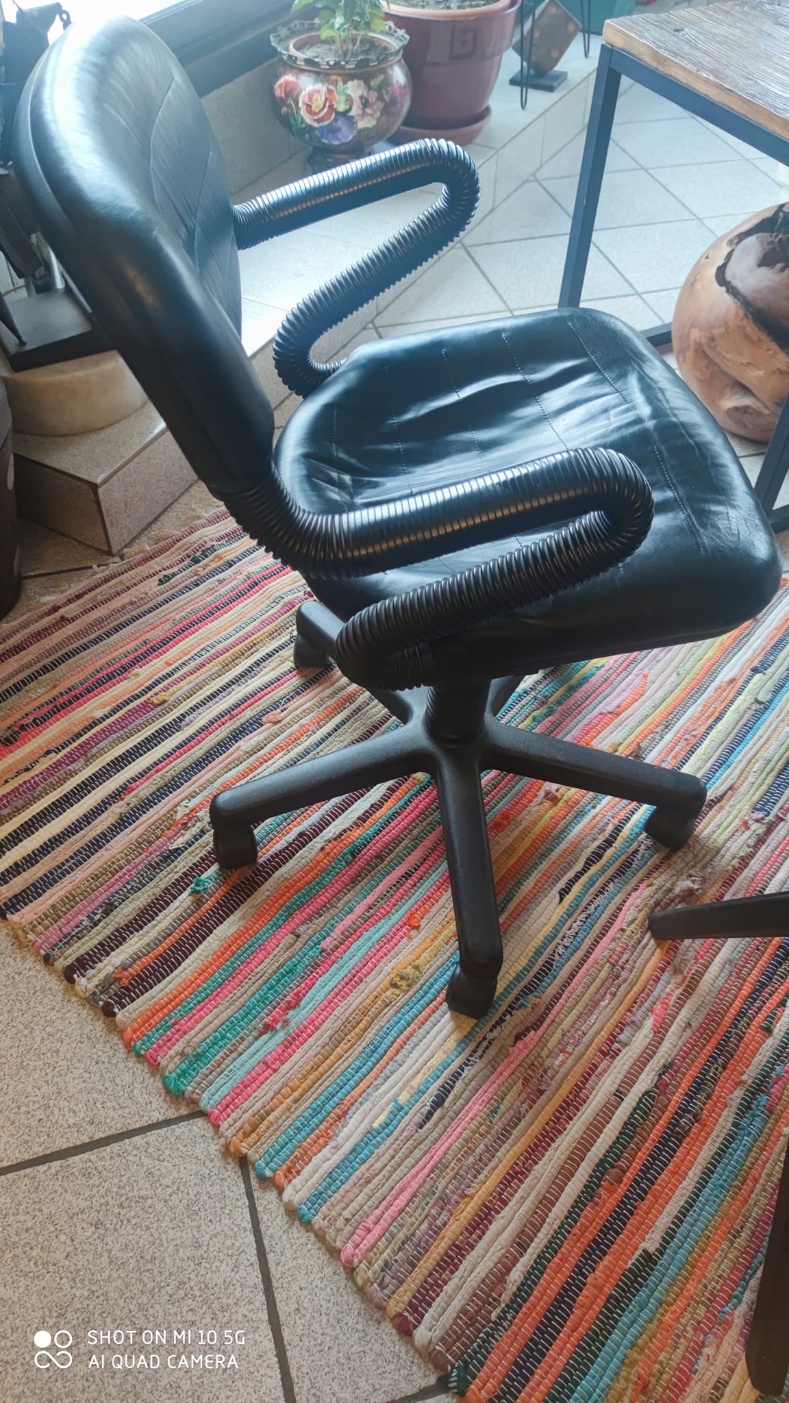 Two black leather armchairs