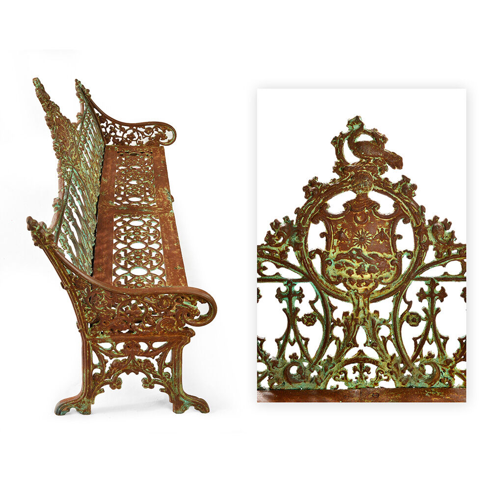 Sculpted cast iron bench with green patina