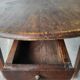 Antique round farmhouse table with drop-leaf doors in solid pegged wood