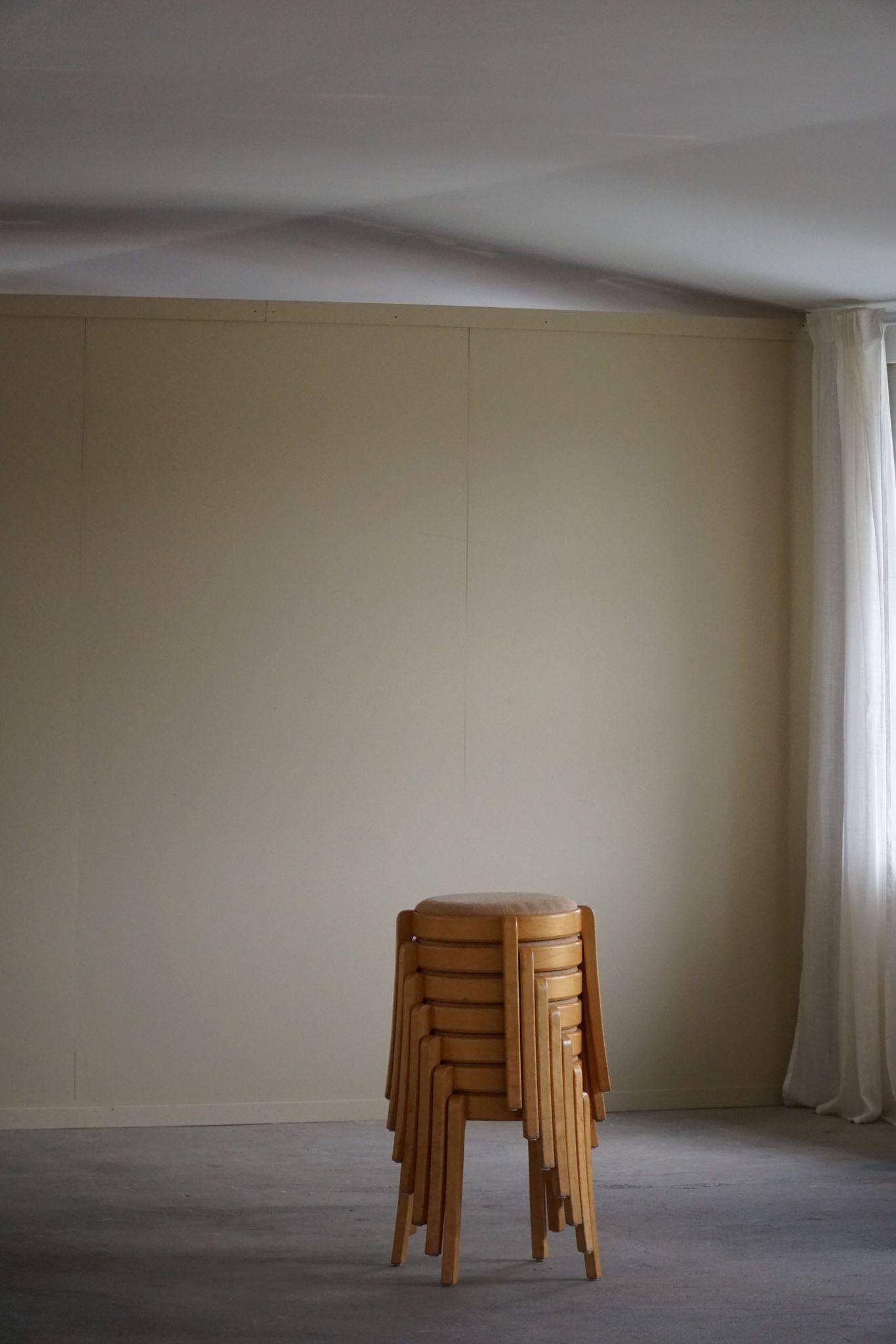 Modern Swedish, set of 14 stackable stools in birch and hessian fabric, 1980s.