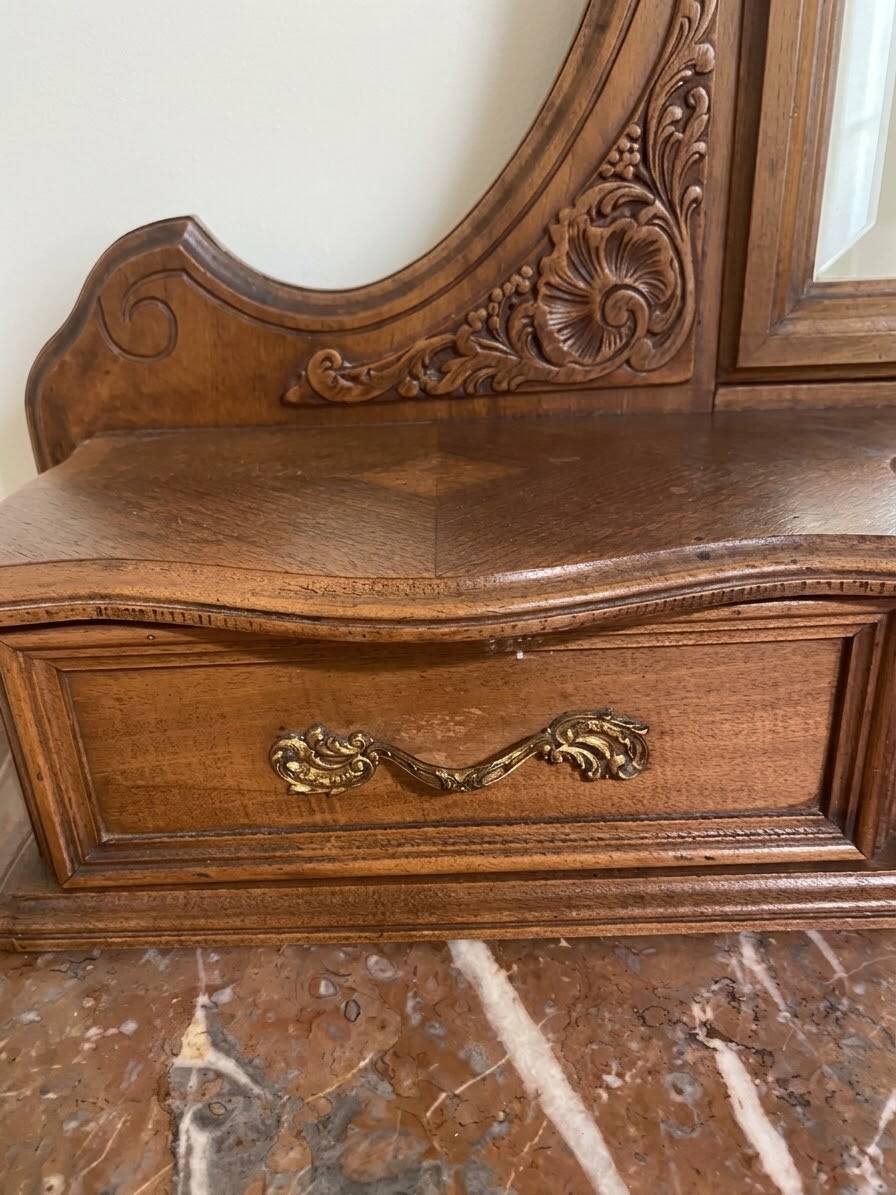 Antique carved wooden dressing table with marble and mirror.