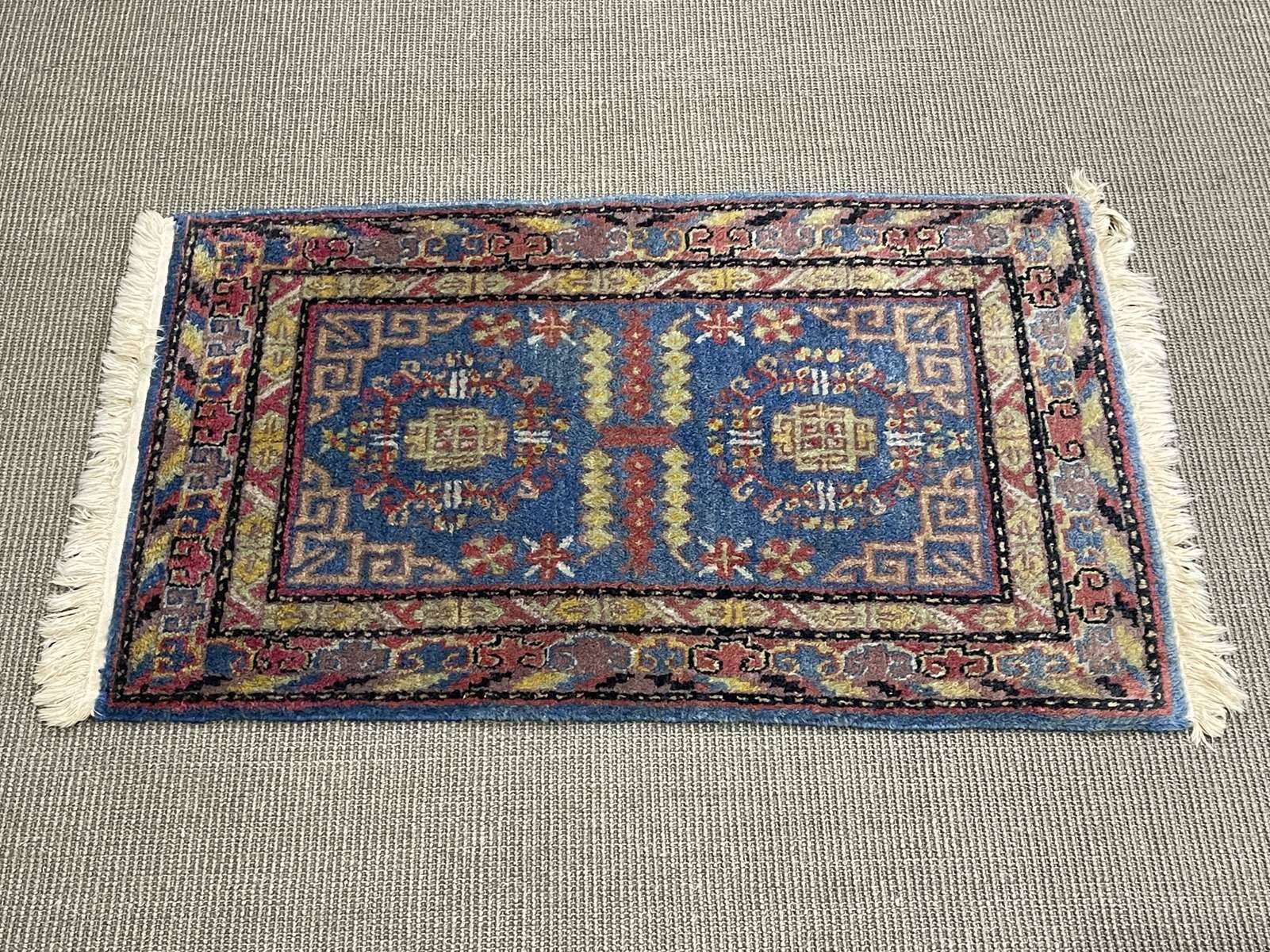 Small handmade wool Iranian rug.
