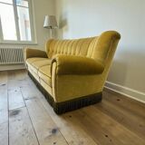 Vintage yellow-green fringed three-seater sofa