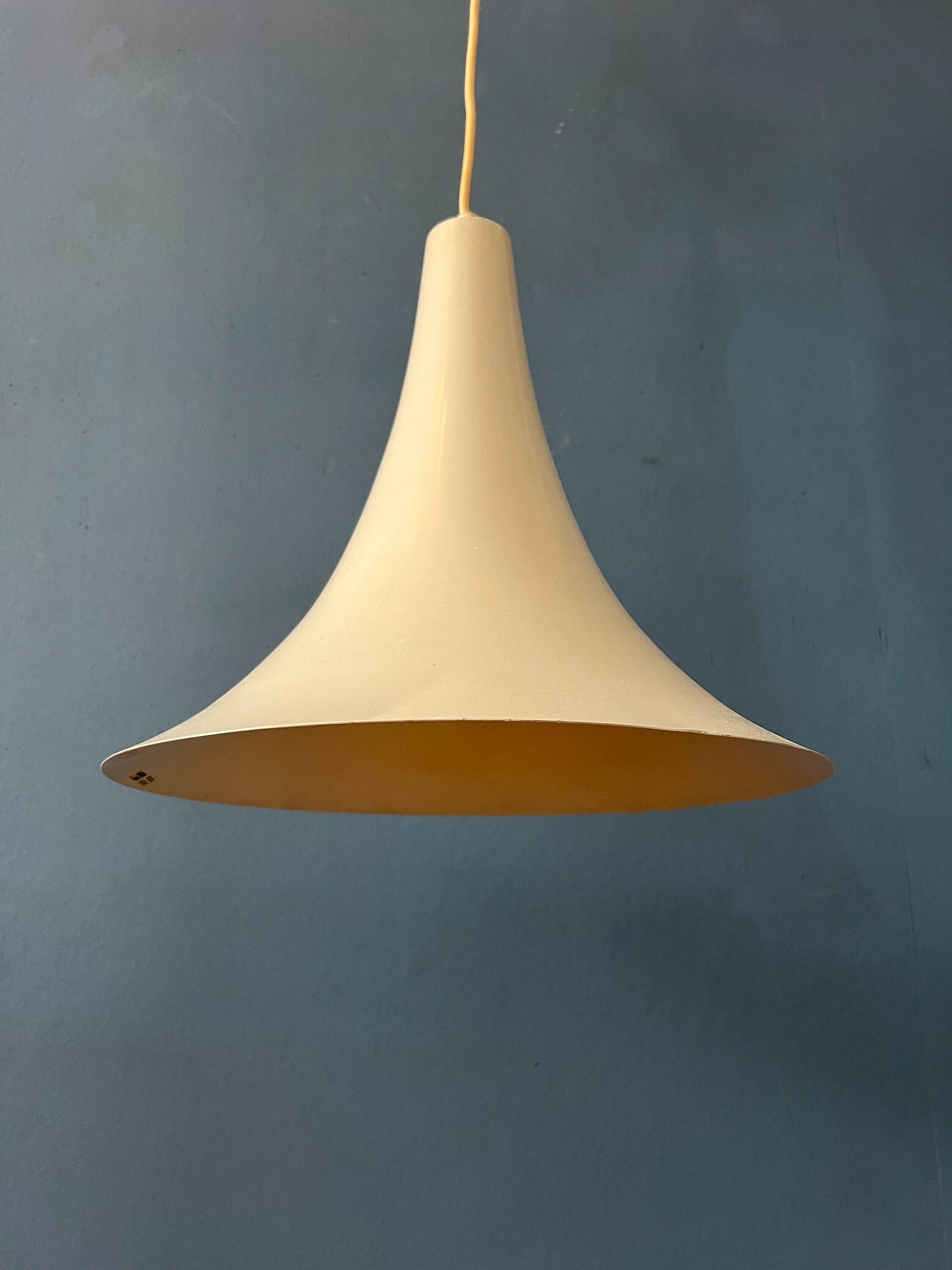 Small vintage beige pendant light in the shape of a witch's hat.