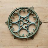 Antique round turquoise cast iron trivet.