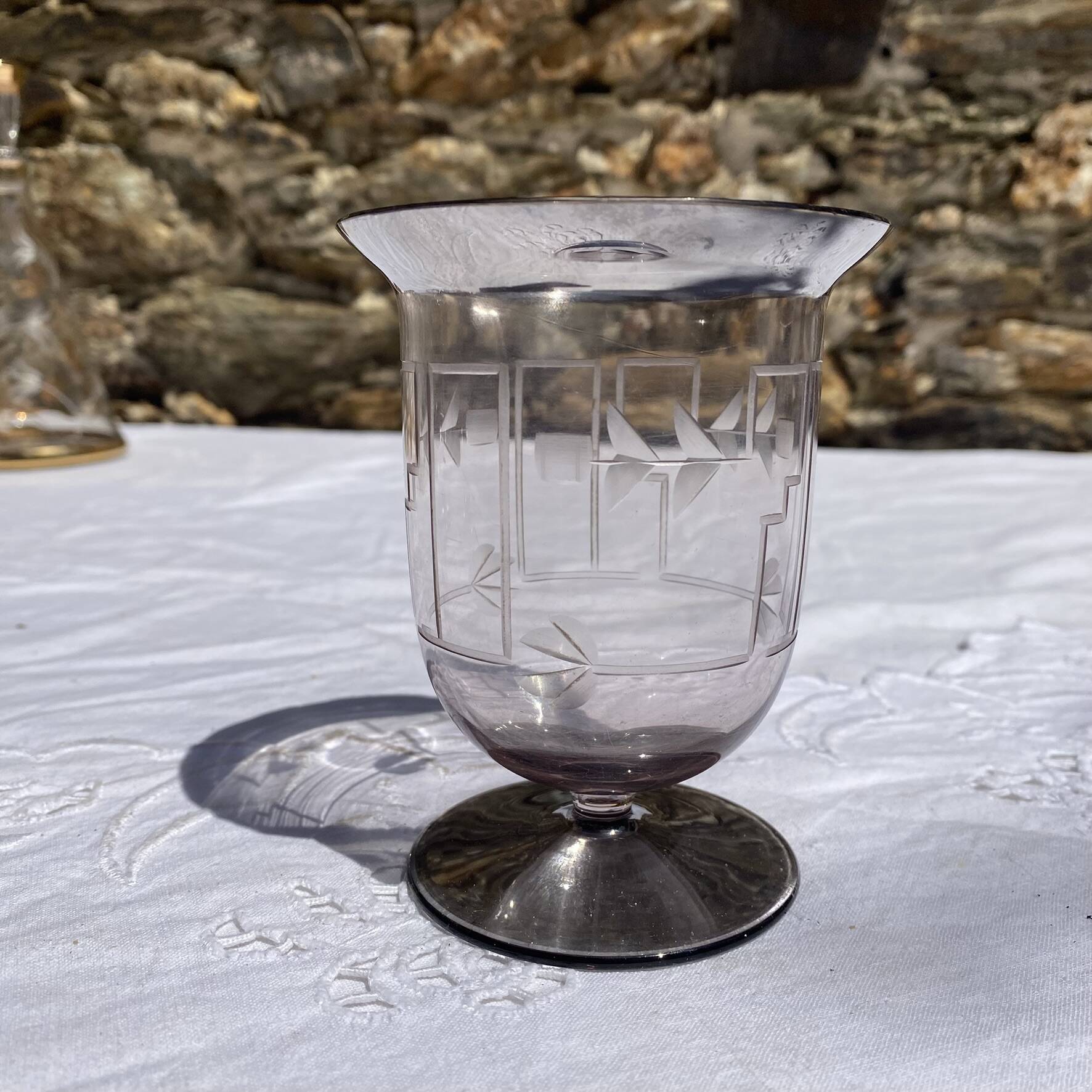 Antique Art Deco engraved glass, silvered rim and base.