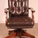 Office chair known as a director's chair in wood and tufted leather.