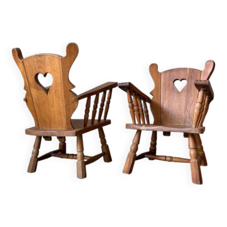 Pair of rustic oak armchairs – carved heart backrests