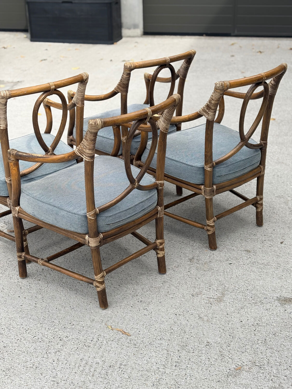 Set of 4 vintage McGuire rattan chairs with cushions.