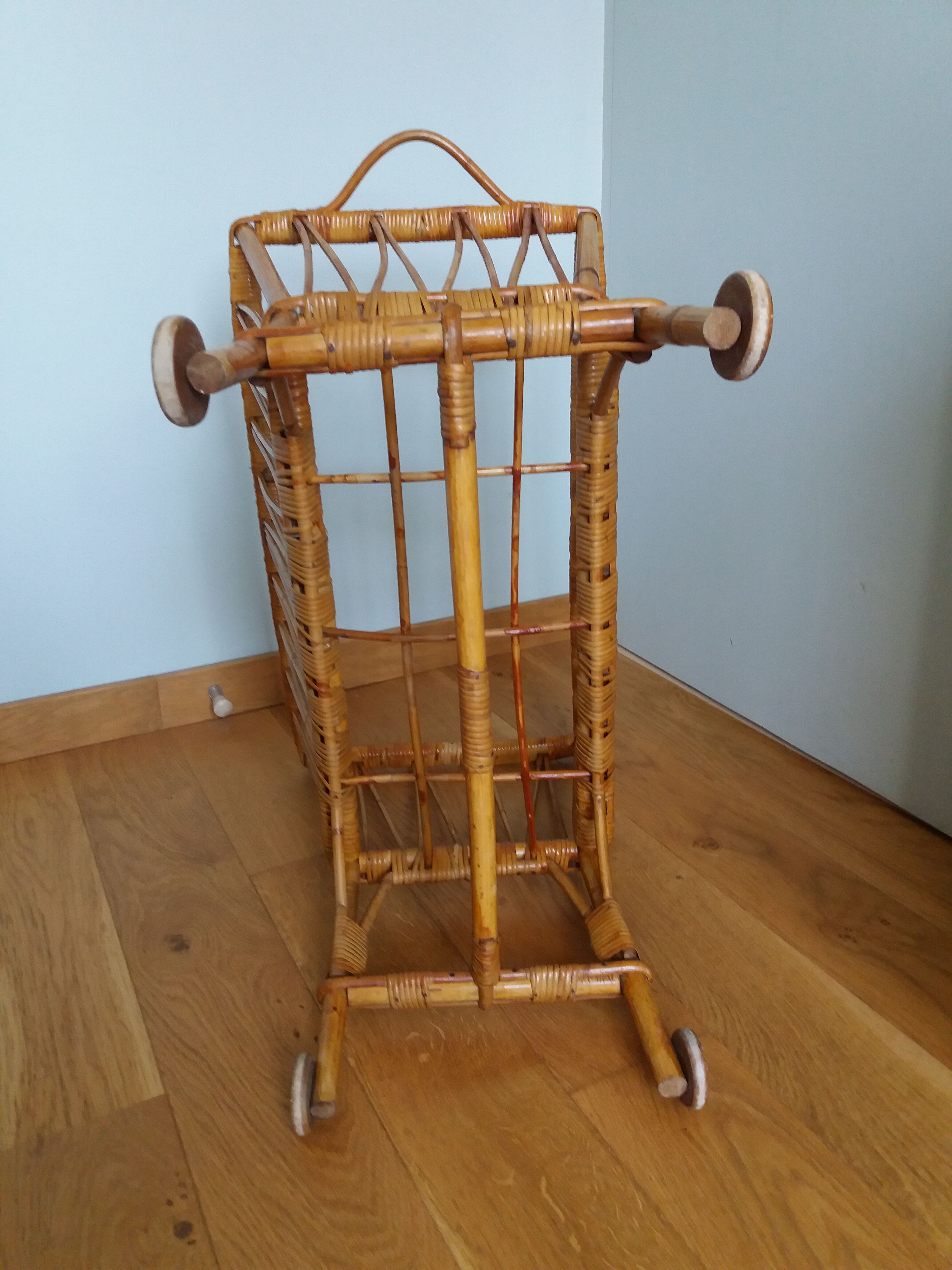Rattan wicker cradle on wooden wheels