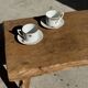 Pair of white porcelain cups from ADP France with a floral pattern and their s