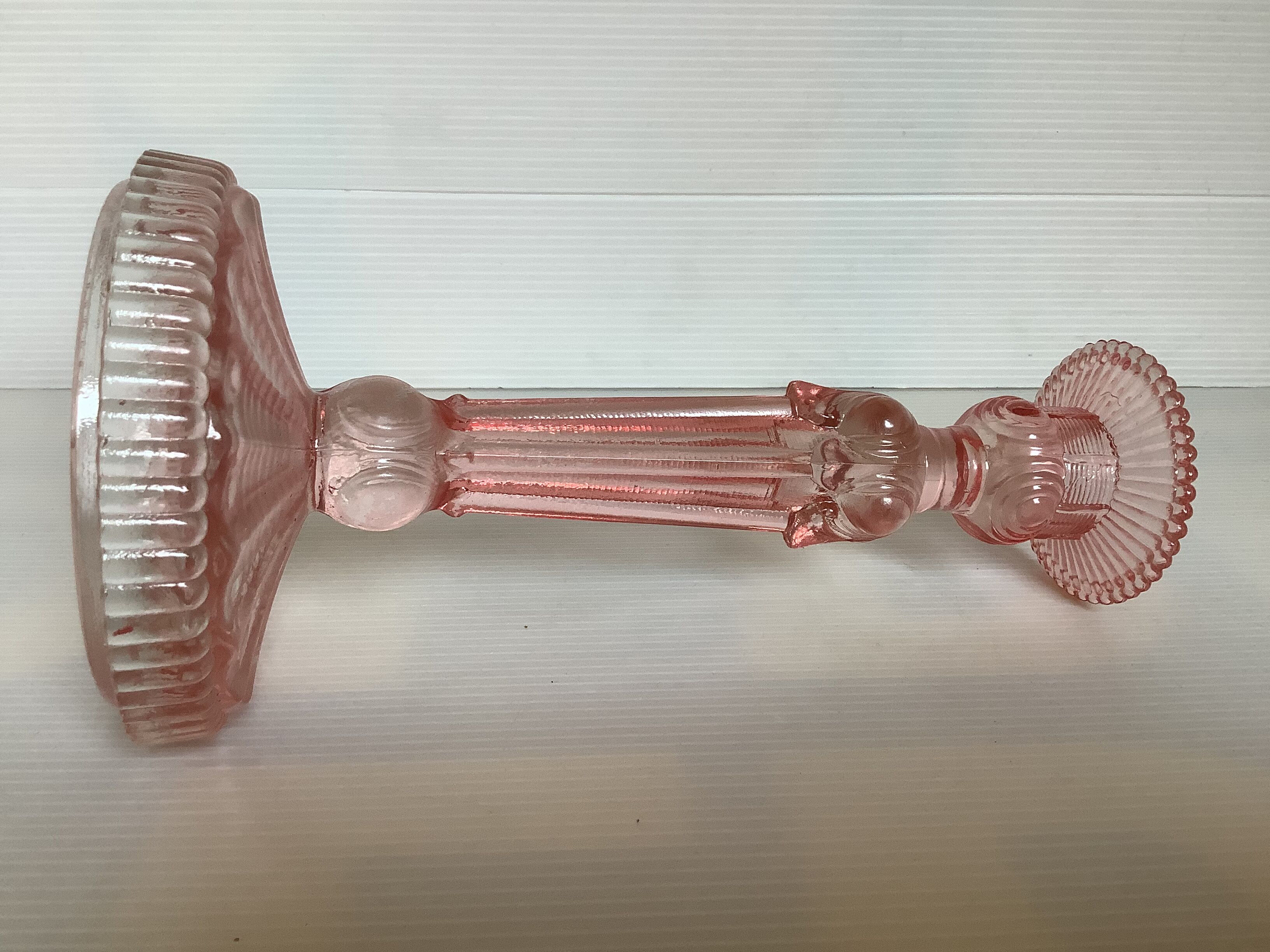 Old pink glass candlestick in Rosaline style.