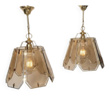 Pair of vintage pendant lights in smoked glass and gold metal, Hollywood style.