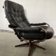 Scandinavian swivel lounge chair in black leather with a bent wood frame, 1970s.