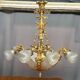 Golden bronze chandelier in Louis XVI style. 12 light points.