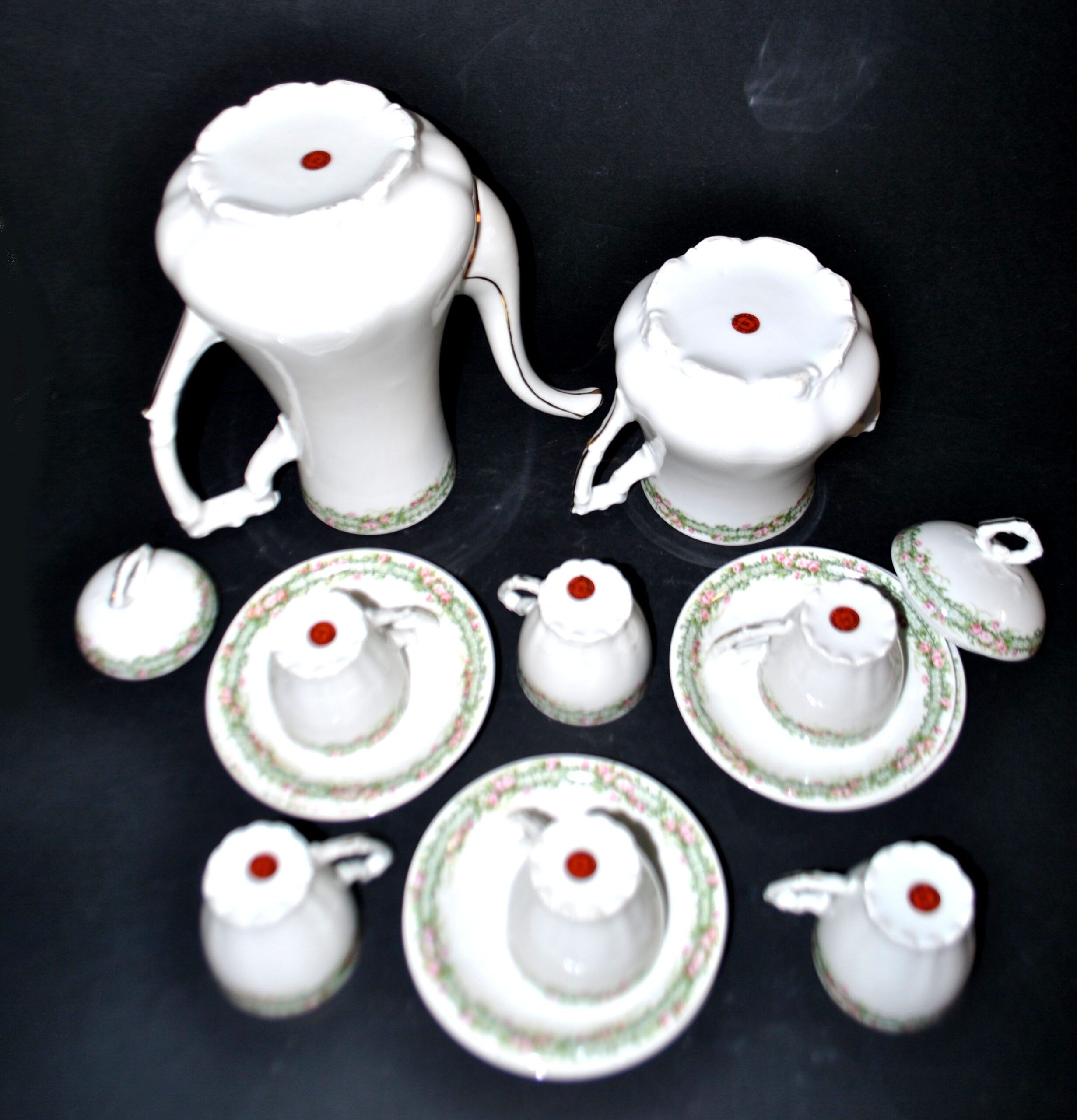 Vintage Limoges coffee service with pink and green floral decoration, coffee pot, sugar bowl, and 6 cups.
