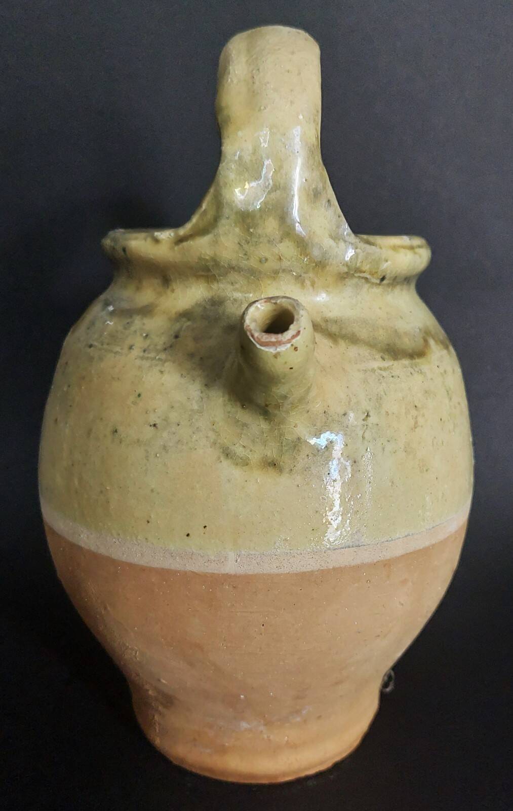 Yellow glazed terracotta gargoulette carafe with lid, early 20th century.