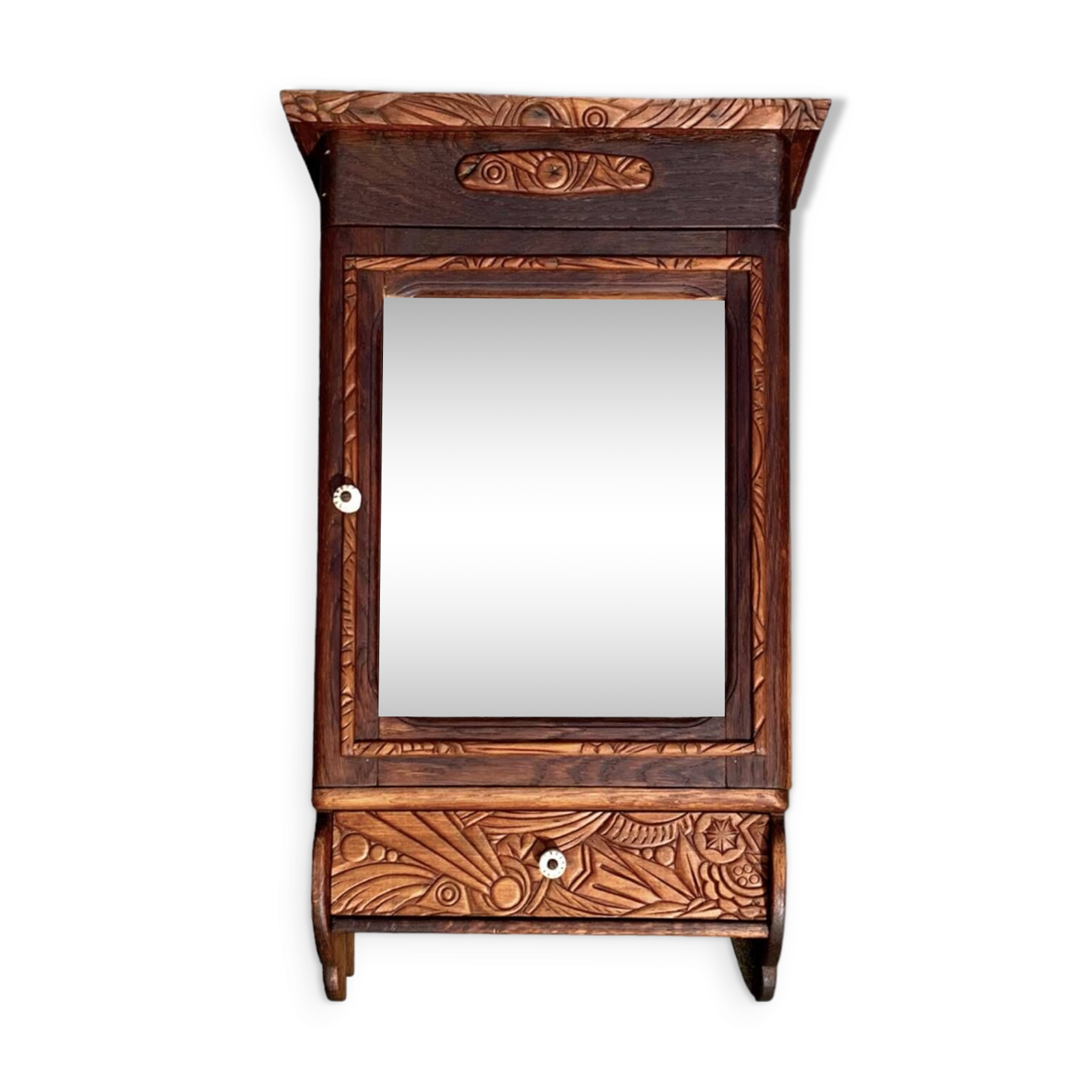 Old carved wooden medicine cabinet with beveled mirror