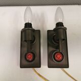 A set of Vitrika Denmark, cast iron wall lights with red details.