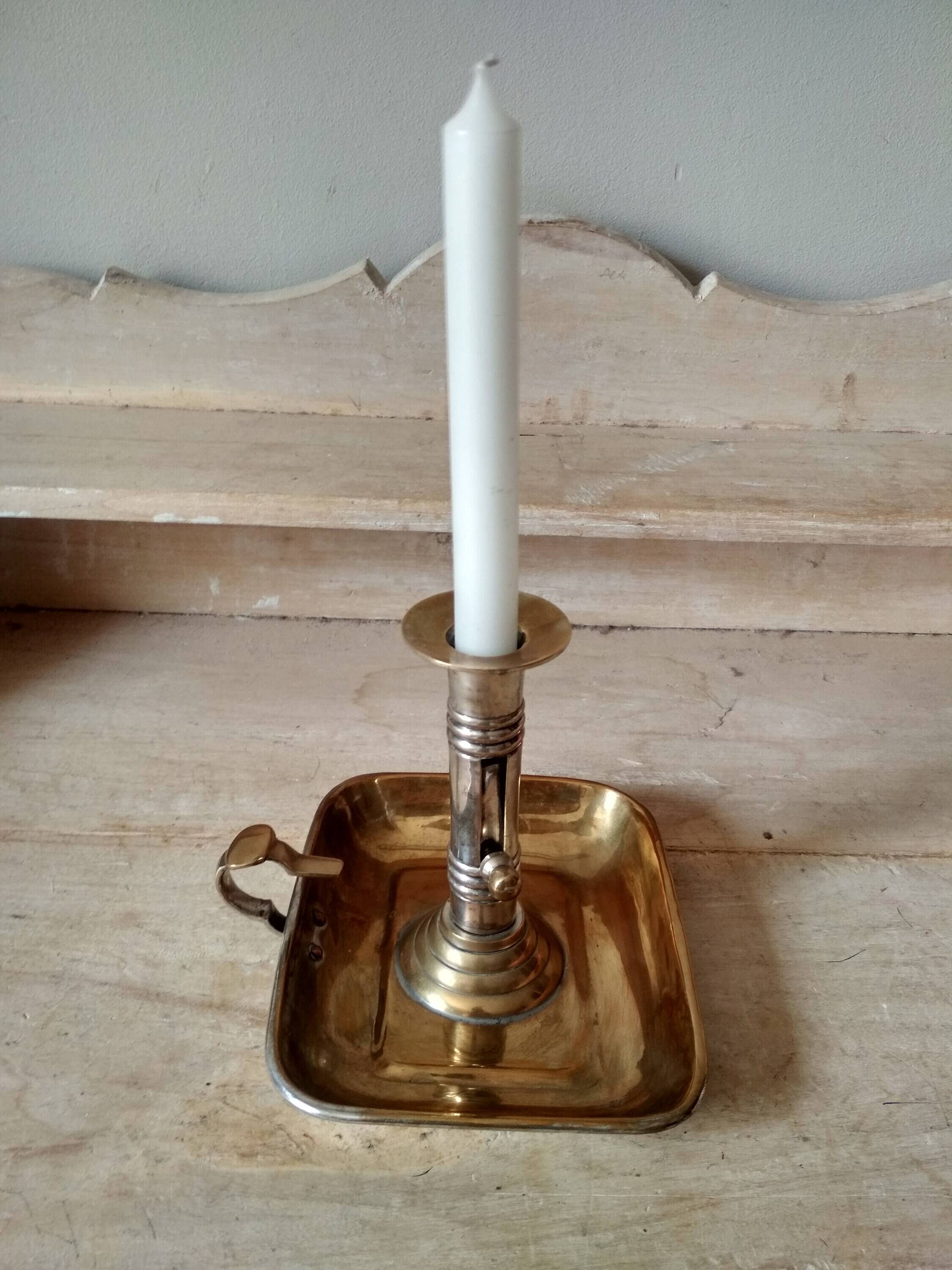 Antique metal and brass hand candle holder on rectangular base