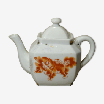 Old  porcelain teapot decorated with dog Fô