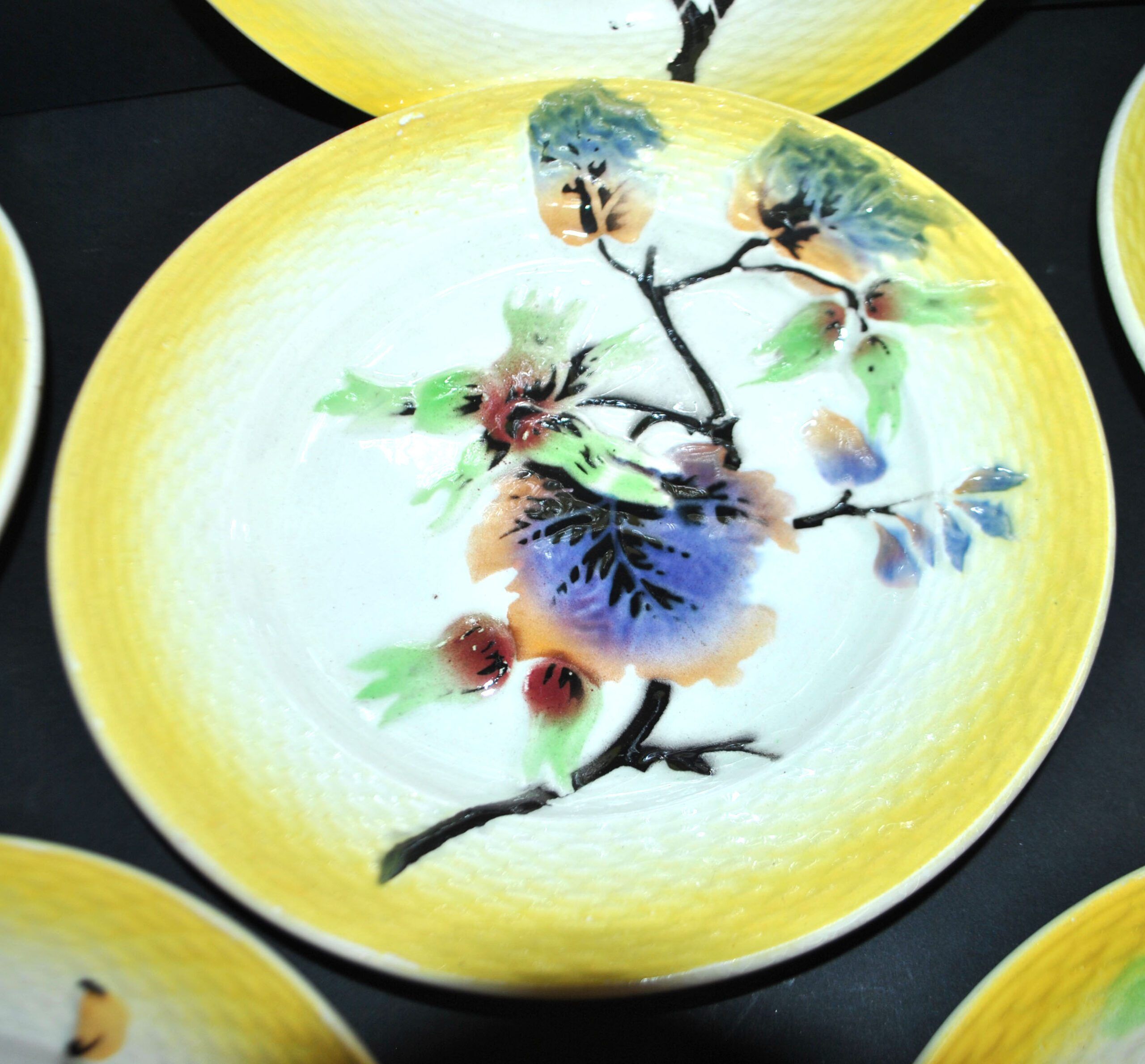 Orchies set of 6 yellow earthenware dessert plates with stencilled fruit decoration.