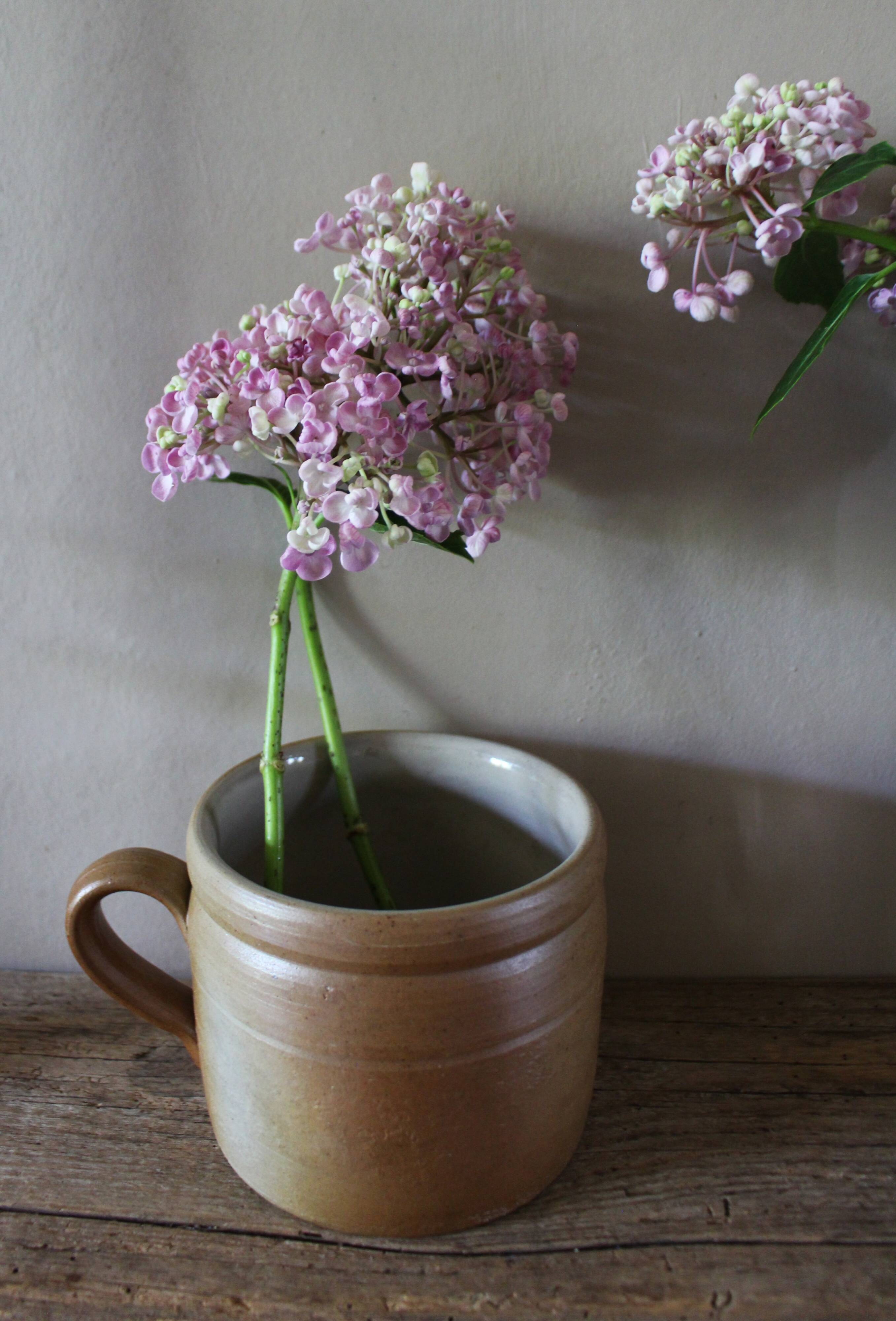 Vase terracotta milk jug with a glazed interior handle.