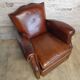 Club chair with moustache back and lion feet.