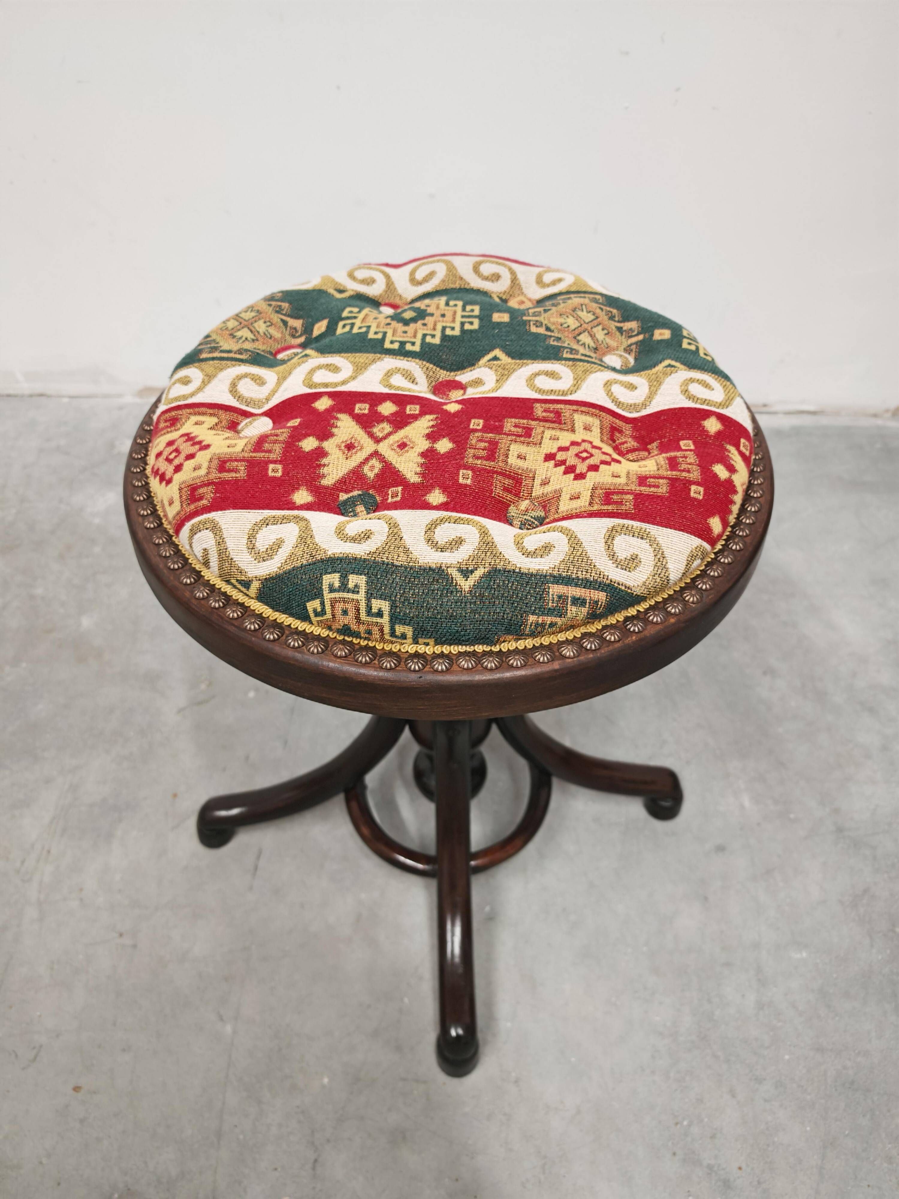 Antique curved wooden piano stool with kilim fabric from the 1910s.
