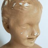 Bust of a small child in ancient plaster