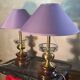 A pair of vintage table lamps featuring a turned wooden base, accessories...