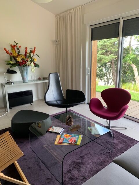 Moroso Fjord armchair with its pouf, design Patricia Urquiola 2002, steel and smooth black leather