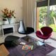 Fjord armchair by Moroso with its pouf, designed by Patricia Urquiola in 2002, made of steel and smooth black leather.