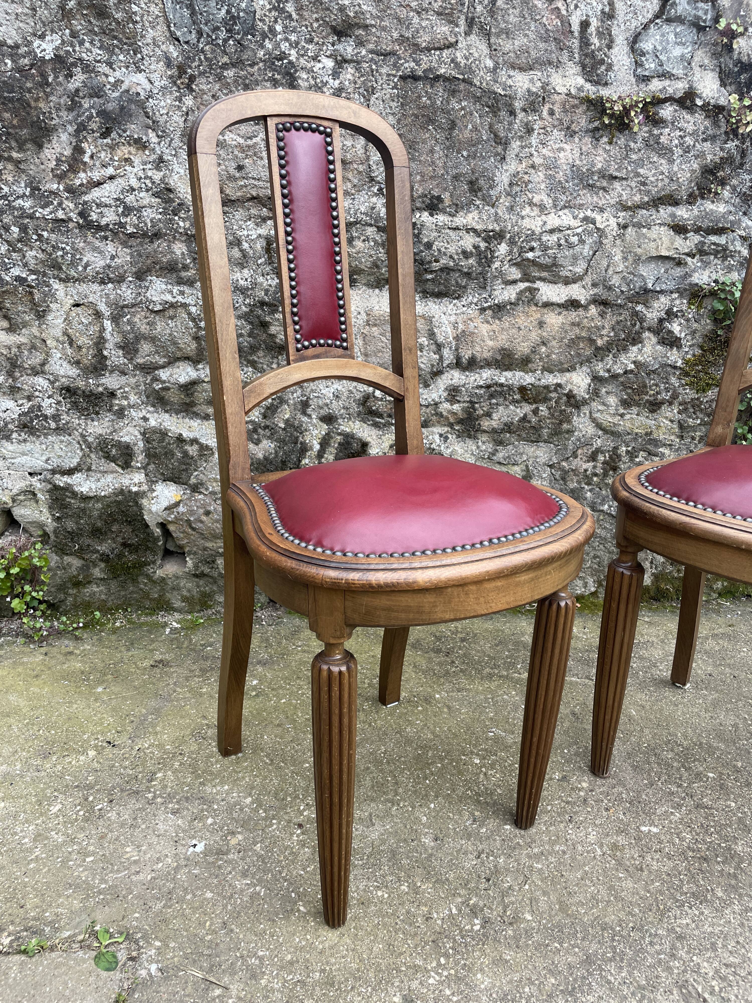 Pair of studded burgundy leather Art Deco chairs