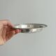 Round patinated silver-plated metal dish